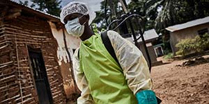 A staff member wears a mask and gown to protect themselves from Ebola. 