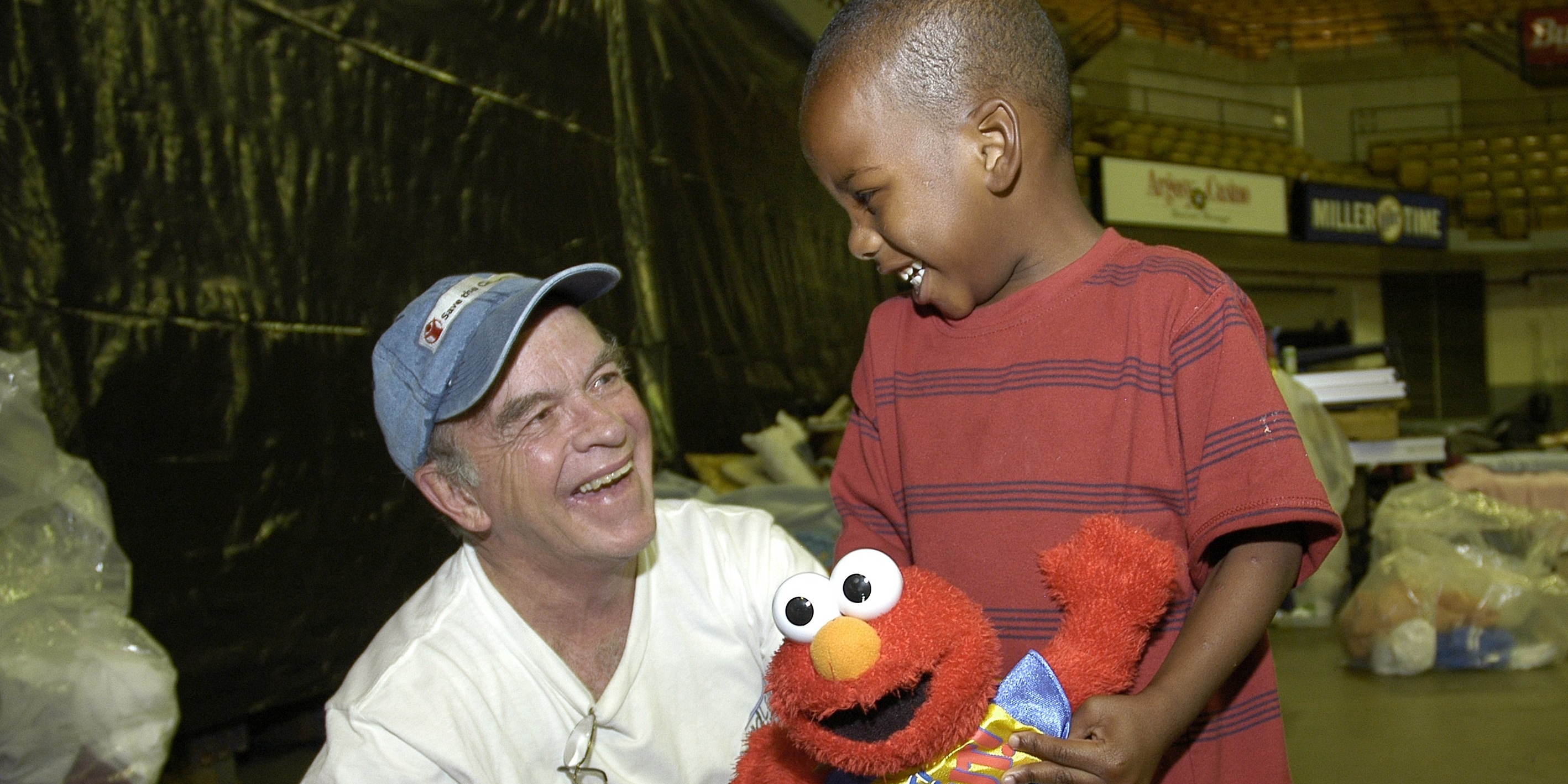 A three-year-old shares a moment of fun with Save the Children's emergency response specialist, Dudley Conneely, at a center Baton Rouge, Louisiana. Save the Children set up child-friendly places to help children recovering from Hurricane Katrina have a safe place to play and recover, while their parents work to rebuild their lives. Photo Credit: Jim Loring/Save the Children 2005.