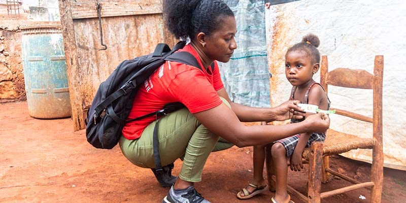 In Haiti, a Save the Children Health worker screens a child for malnutrition.