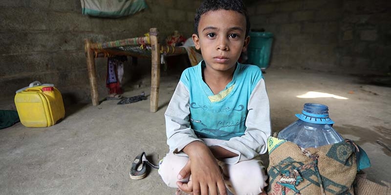 A young boy inside the home that he shares with his family in a rural region of Yemen