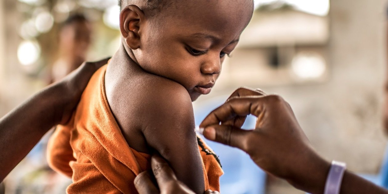 A one-year-old child prepares to receive his Yellow Fever vaccination in the Binza Ozone district of Kinshasa, Democratic Republic of Congo. Photo Credit: Tommy Trenchard, August 2016 